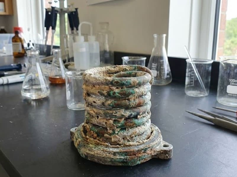 Calcified heating element showing damage from untreated hard water